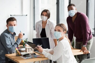 working-team-office-during-pandemic-wearing-face-masks_23-2148666331